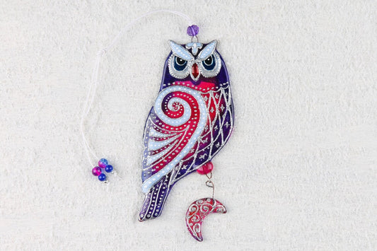 Hand-painted glass artwork of wise owls with sun and moon symbols, blue and red